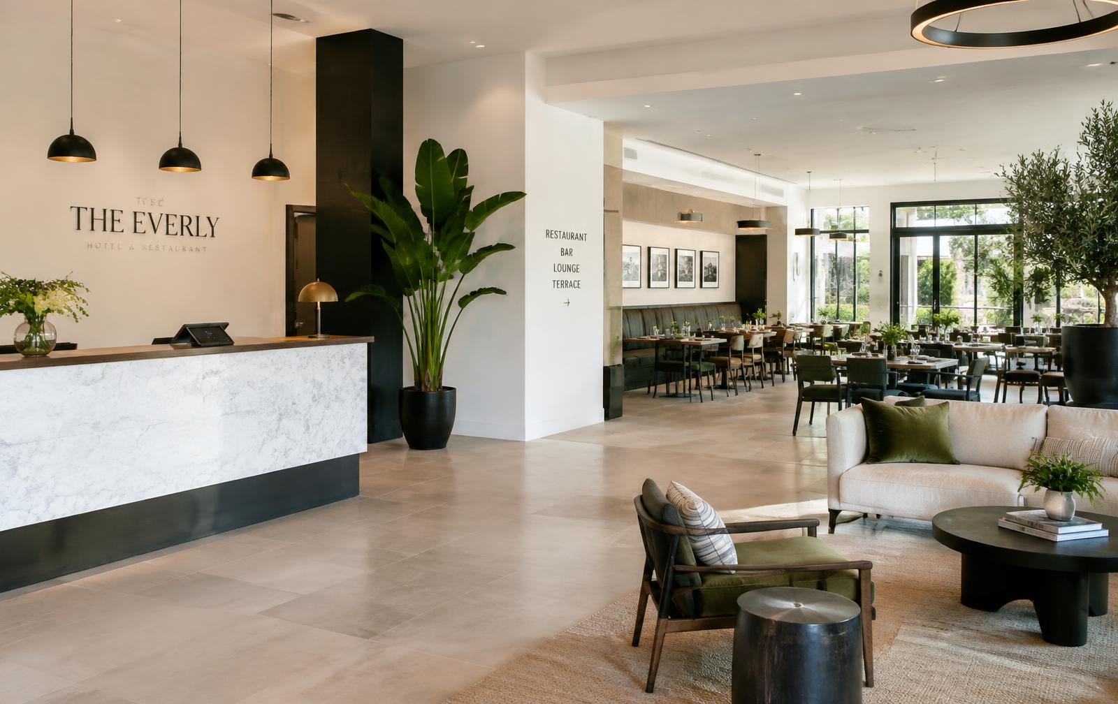 Hotel lobby with front desk and restaurant